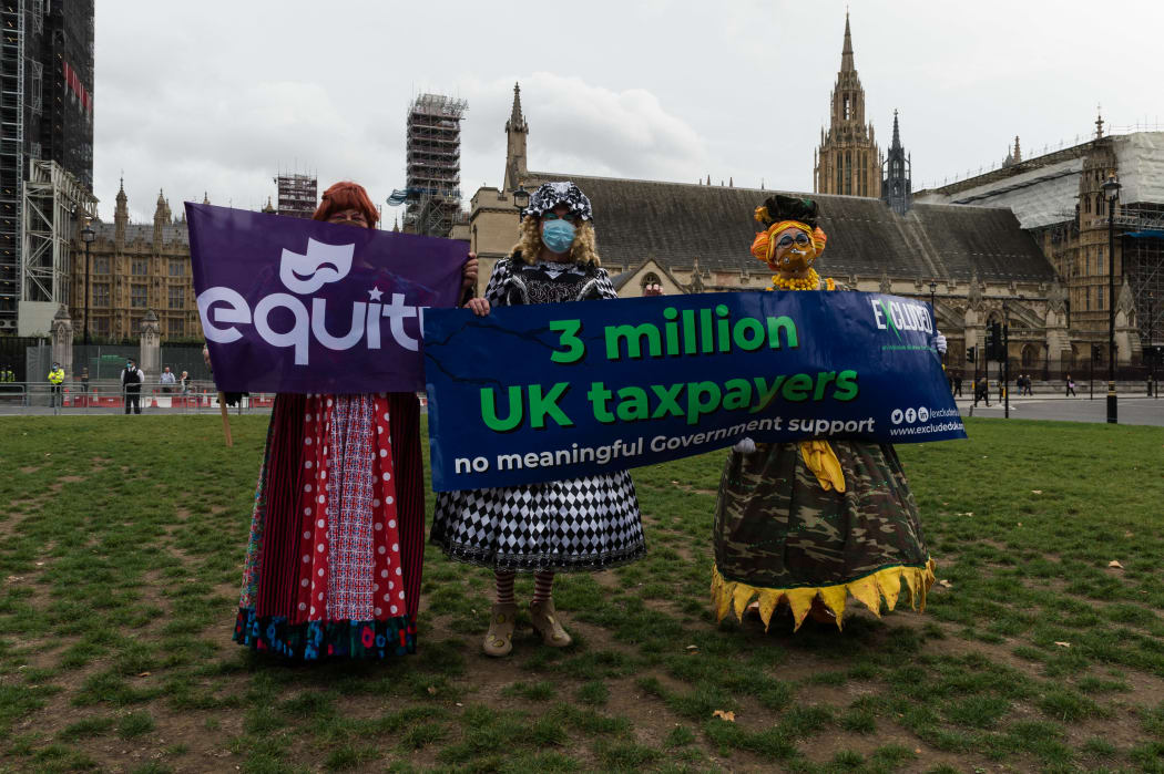 Pantomime dames in colourful costumes gather in Parliament Square after marching through central London to highlight the plight of the live events industry, on 30 September 2020 in London, England.