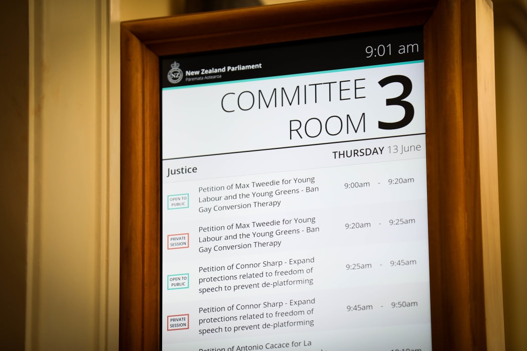 A sign for a select committee room at Parliament shows what the committee is working on.