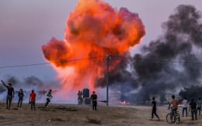 Palestinians use improvised explosive devices amid clashes with Israeli security forces in Khan Yunis in the southern Gaza Strip on September 27, 2023, following a protest near the border fence. (Photo by SAID KHATIB / AFP)