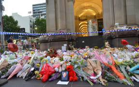 People lay flowers on Bourke street in Melbourne on January 22, 2017, after after a man went on a rampage in a car.