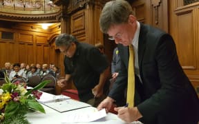 Lead Negotiator Jason Kerehi and Minister for Treaty of Waitangi Negotiations Christopher Finlayson, initialling the Deed of Settlement.