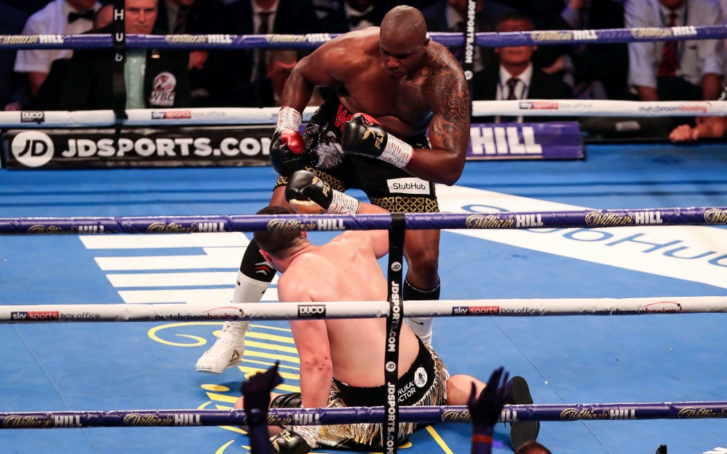 Dillian Whyte floors Joseph Parker during their WBC title fight in London in July.