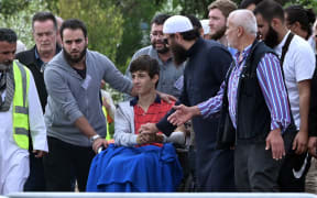 Zaid Mustafa (in wheelchair), who was wounded by the gunman, attends the funeral of his slain father Khaled Mustafa and brother Hamza Mustafa at the Memorial Park cemetery in Christchurch  today.