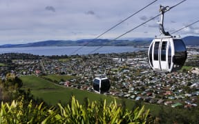 Riding cable car above Rotorua lake and city, in the centre of North Island of New Zealand