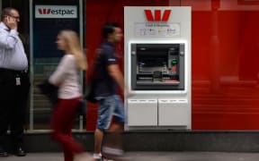 People walk past a Westpac ATM in Sydney