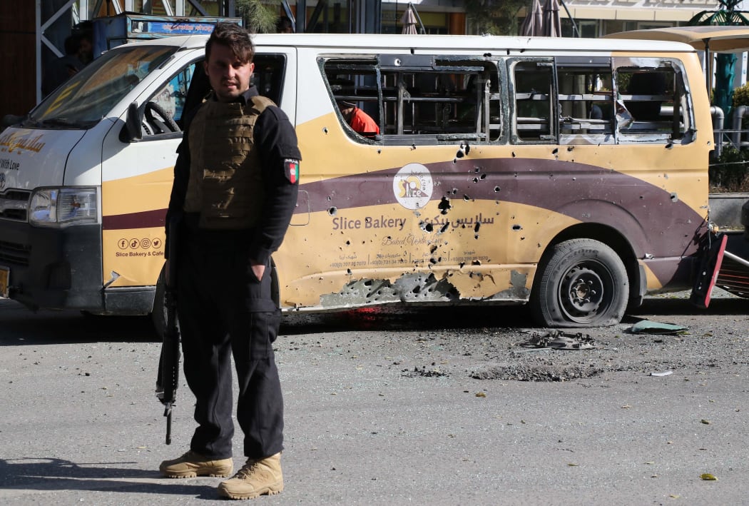 An Afghan security official inspects the scene of the rocket attacks in Kabul.