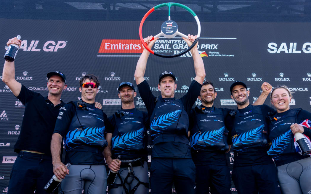 The New Zealand SailGP Team helmed by Peter Burling on stage celebrating victory on Race Day 2 of the Emirates Sail Grand Prix presented by P&O Marinas in Dubai, United Arab Emirates. 10th December 2023. Photo: Felix Diemer for SailGP. Handout image supplied by SailGP