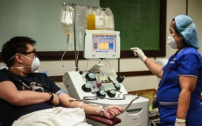 A patient who has recovered from the COVID-19 coronavirus donates plasma at a hospital in Manila on April 22, 2020. - Scientists have pointed to the potential benefits of plasma -- a blood fluid