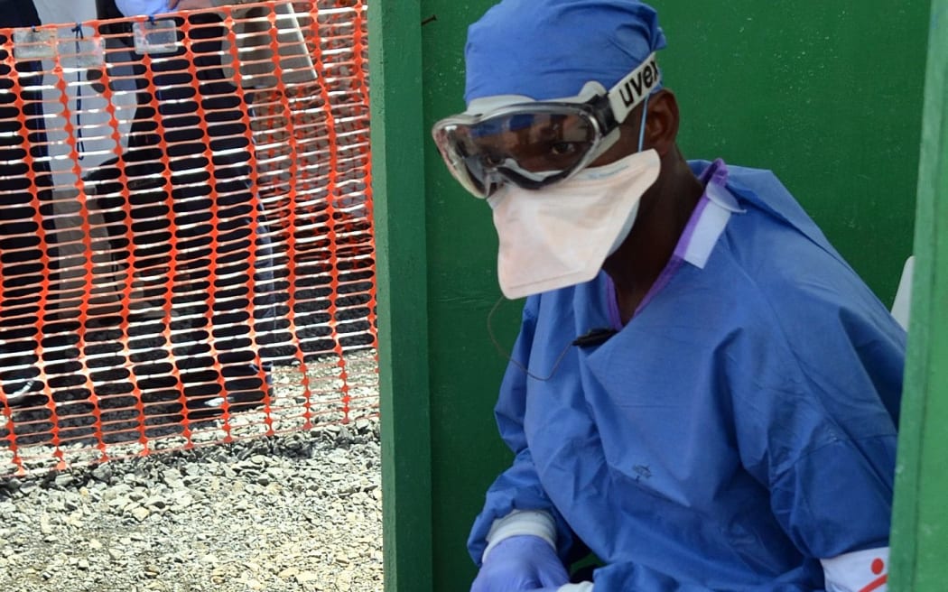 A health worker sits at MSF's Ebola treatment centre inside the Samuel K Doe stadium in Monrovia, Liberia.