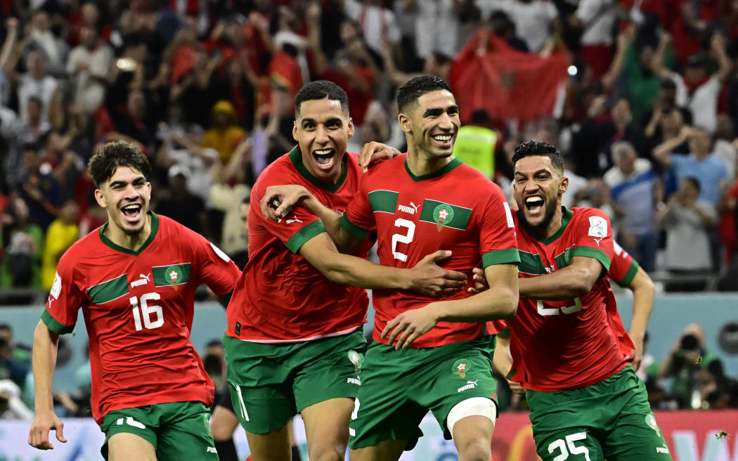 Morocco players celebrate their penalty shootout win over Spain at the 2022 World Cup.