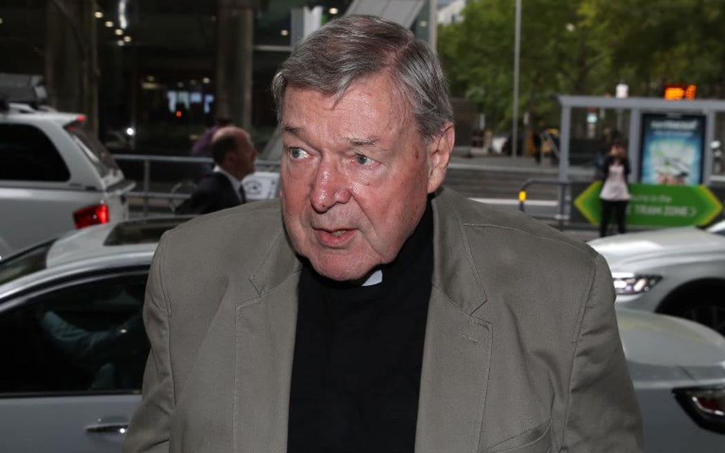 Cardinal George Pell arrives under police protection for a hearing at the Melbourne Magistrates Court in Melbourne on March 29, 2018.