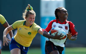 Papua New Guinea's Chelsea Garesa races away from the Brazil defence.