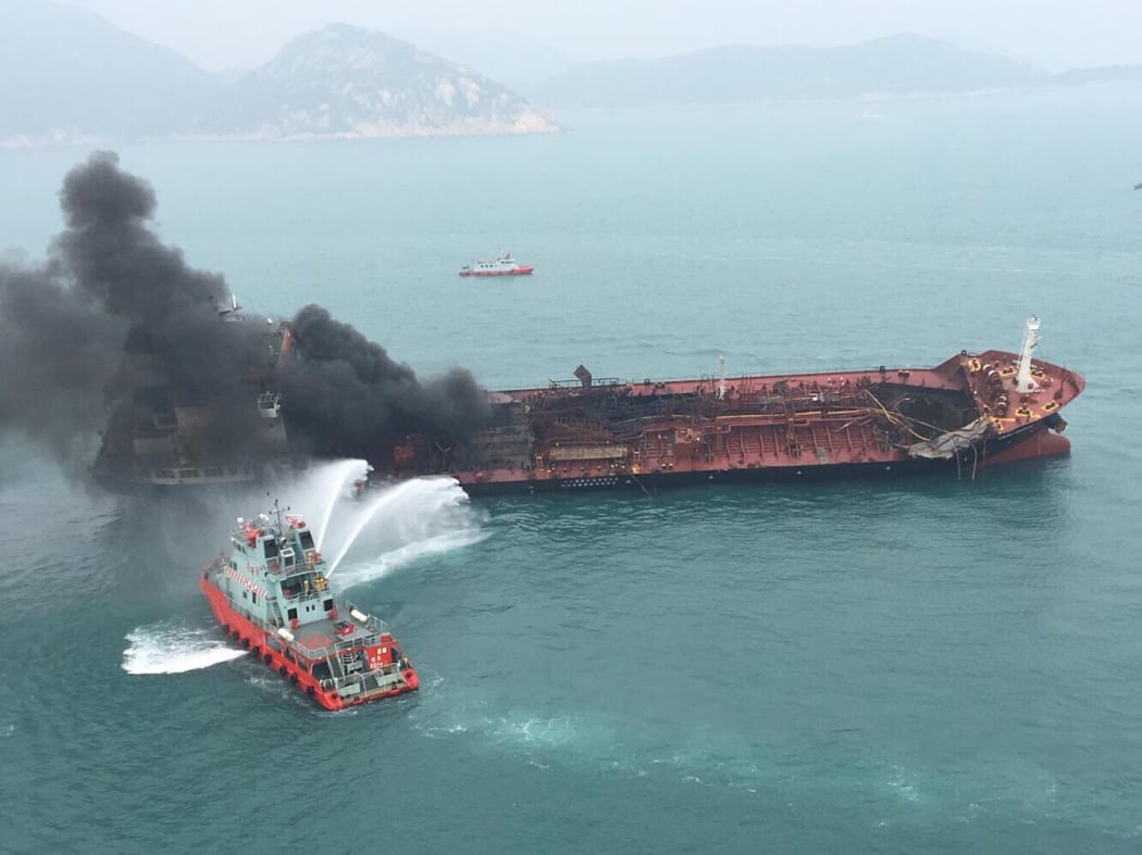 A rescue boat puts out fire that occurred on an oil tanker off Hong Kong's Lamma Island, Jan. 8, 2019.