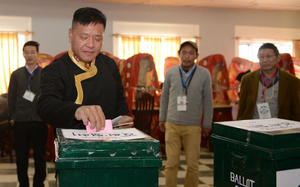 Candidate for Sikyong (Tibetan Prime Minister)Penpa Tsering (2L) casts his vote in leadership elections in Dharamshala on March 20, 2016. - Tens of thousands of exiled Tibetans have voted for a new leader tasked with sustaining their struggle for greater autonomy in their Chinese-ruled homeland as the Dalai Lama retreats from the political frontline. (Photo by Lobsang Wangyal / AFP)