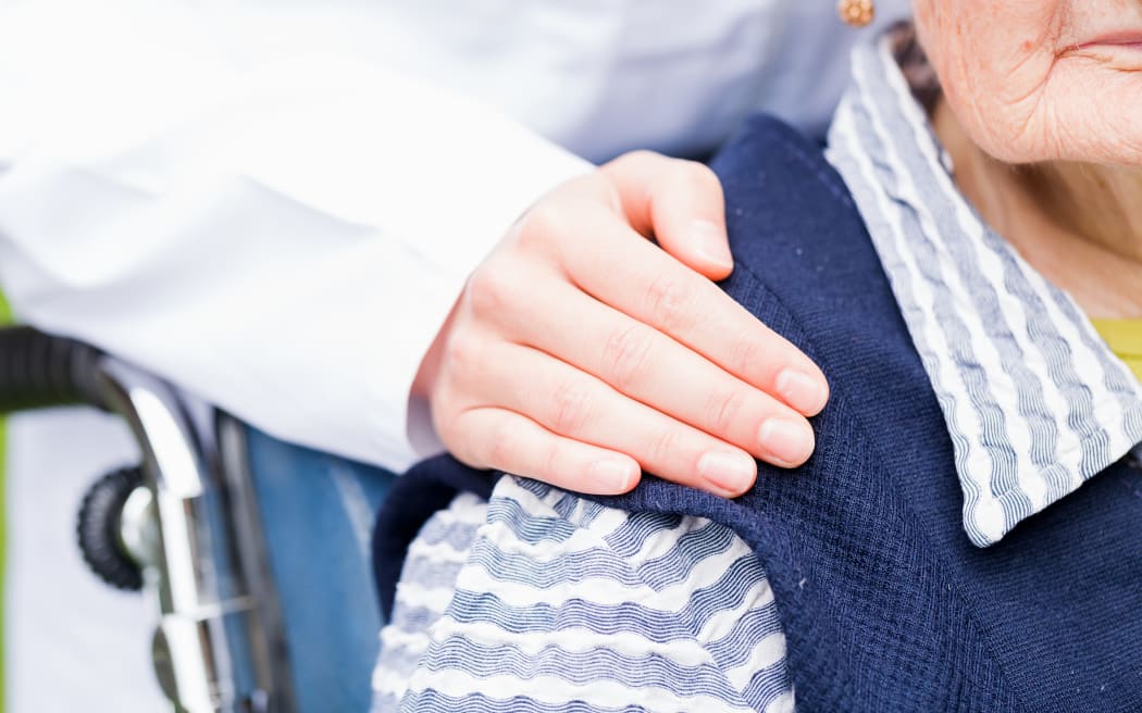 Photo of young carer helping the elderly woman