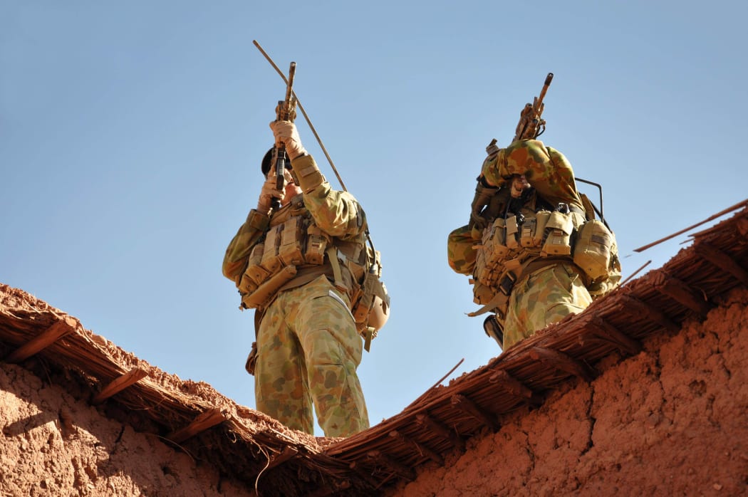 A handout photo released by Australian Department of Defence on October 21, 2009 shows Australian soldiers from the Special Operations Task Group using their rifle scopes to investigate the surrounding mountains during an operation in southern Afghanistan.