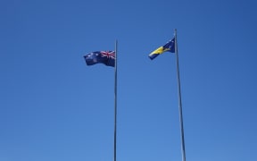 Tokelau and New Zealand flags flying in Atafu, Tokelau