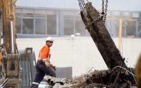 A rescue worker searches the ruins of the CTV building site four days after the 22 February 2011 earthquake.