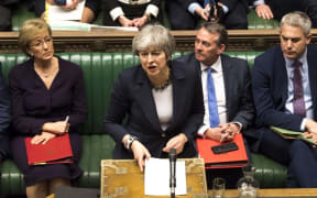 A handout photograph released by the UK Parliament on March 13, 2019 shows Britain's Prime Minister Theresa May responding to the result of a vote in the House of Commons in London