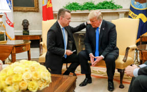 Freed American pastor Andrew Brunson (L) prays for US President Donald Trump at the White House in Washington.