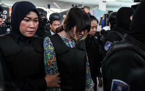 Vietnamese defendant Doan Thi Huong is escorted by police personnel Kuala Lumpur International Airport.