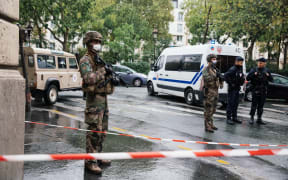 Military and police deployed on Boulevard Richard Lenoir, after two people were stabbed to death near the former premises of Charlie Hebdo.