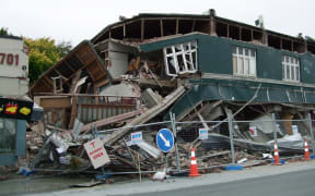 A photo taken on February 22, 2011 shows a collapsed row of shops on Worcester Street in Christchurch.