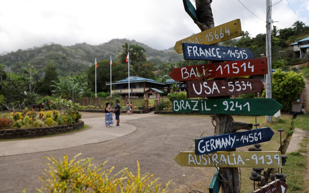 Distance markers to various countries are seen past the main town hall on Hiva Oa, the second largest island of the Marquesas Islands, French Polynesia