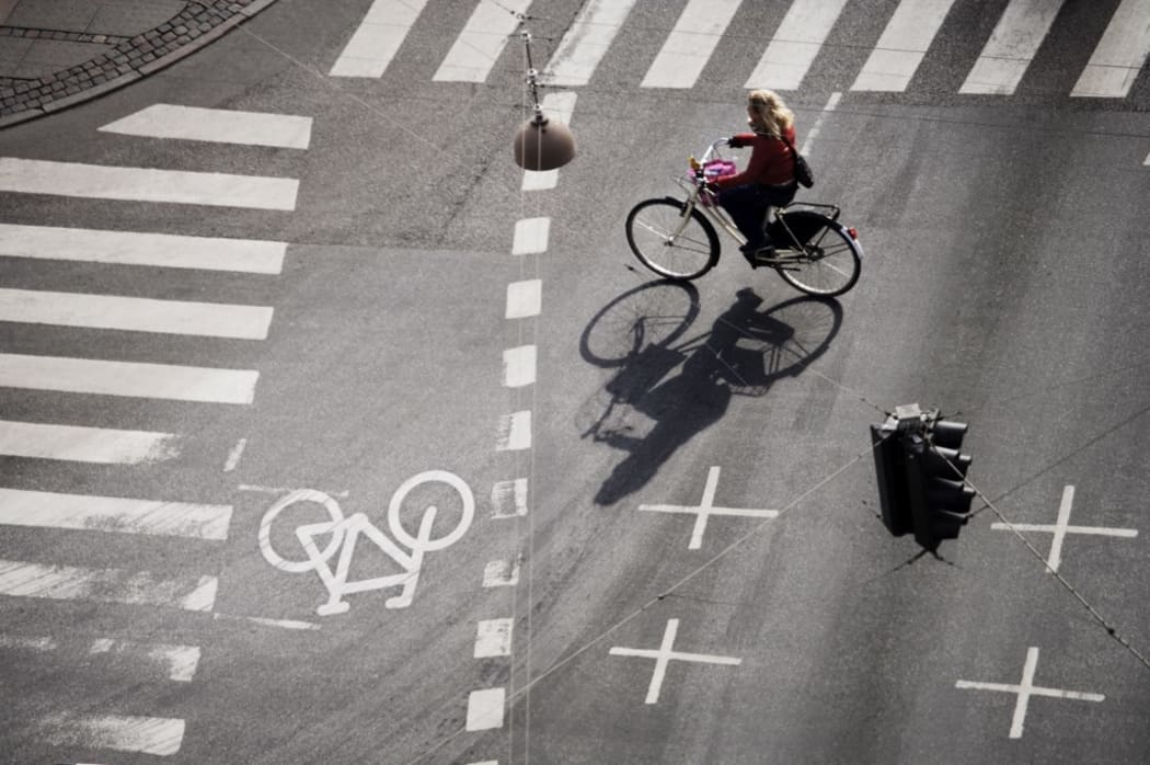 Girl on bicycle at crossroads, Copenhagen, Denmark, Scandinavia, Europe (Photo by Purcell-Holmes / Robert Harding Premium / robertharding via AFP)