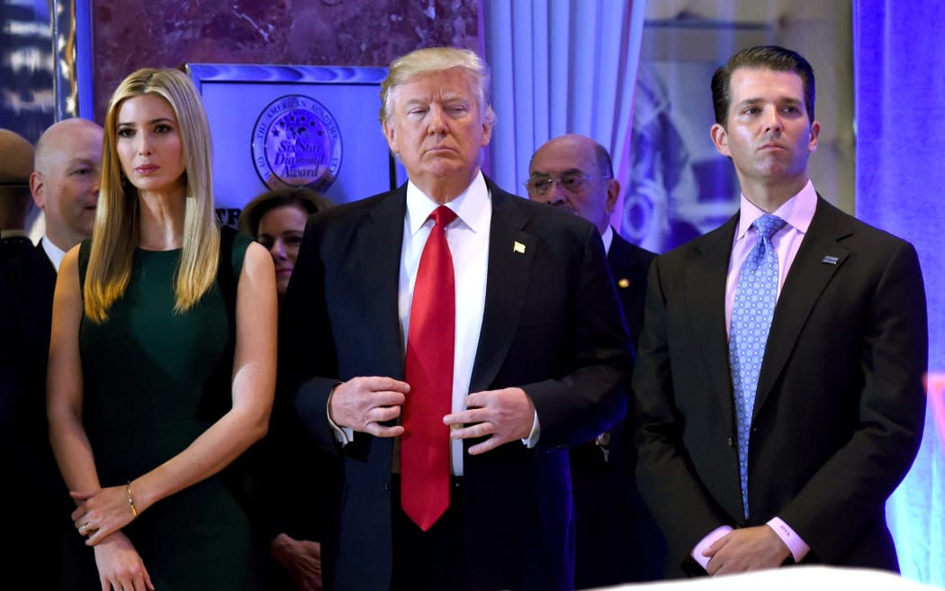 In this file photo taken on January 11, 2017 US President-elect Donald Trump stands with his children Ivanka and Donald Jr., during Trump's press conference at Trump Tower in New York.