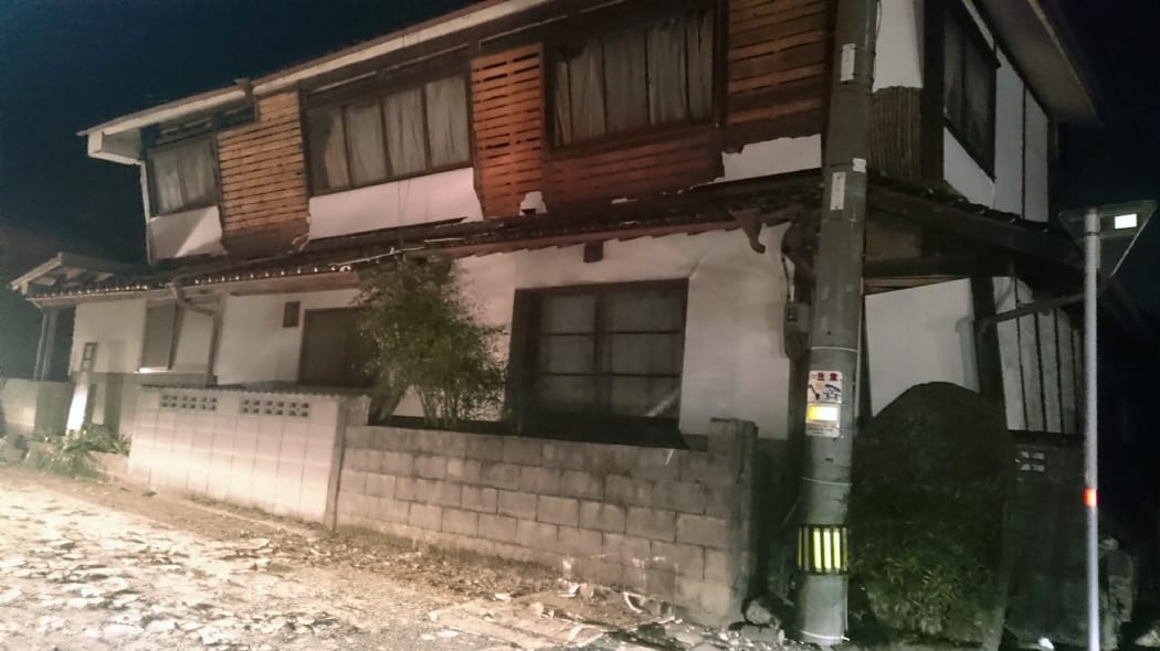 A house tilted and damaged in Kumamoto city.