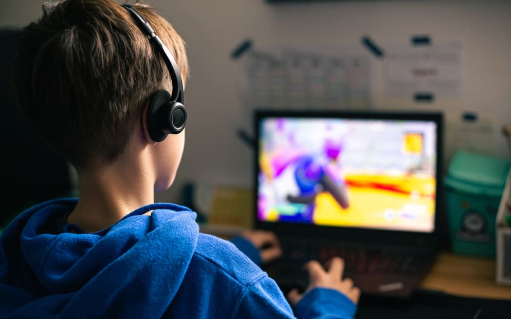 Child playing a video game at home.
