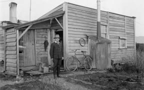 Joseph Divis outside his hut in Waiuta.