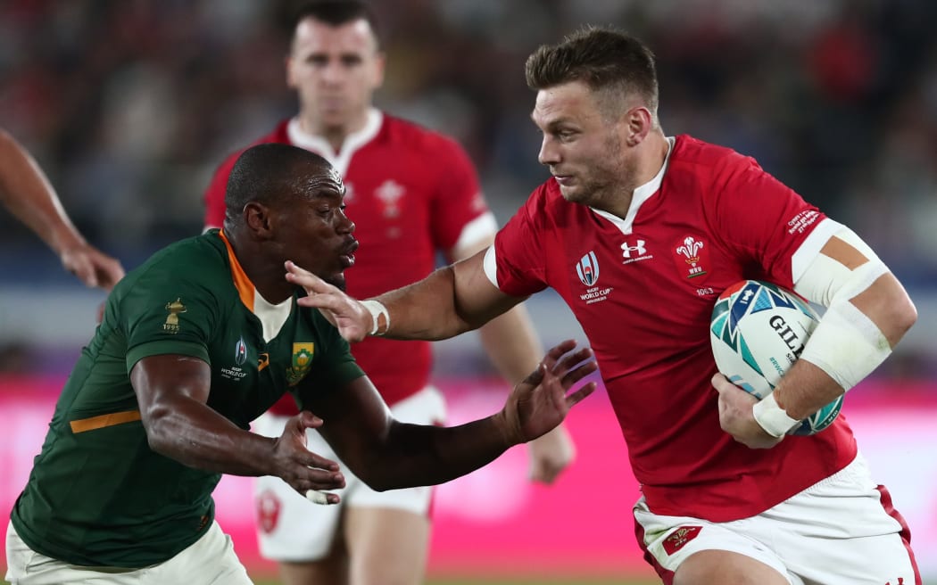 South Africa's wing Makazole Mapimpi (L) tackles Wales' first five Dan Biggar during the Japan 2019 Rugby World Cup semi-final match between Wales and South Africa.