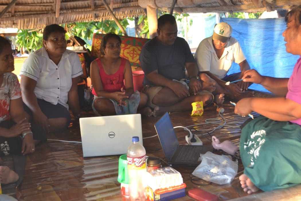 Lab technologists in Kiribati training nurses on an outer island to perform pap smear tests.