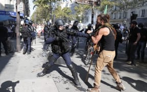A demonstrator clashes with riot policemen during the Climate Change protest, on September 21, 2019 in Paris.