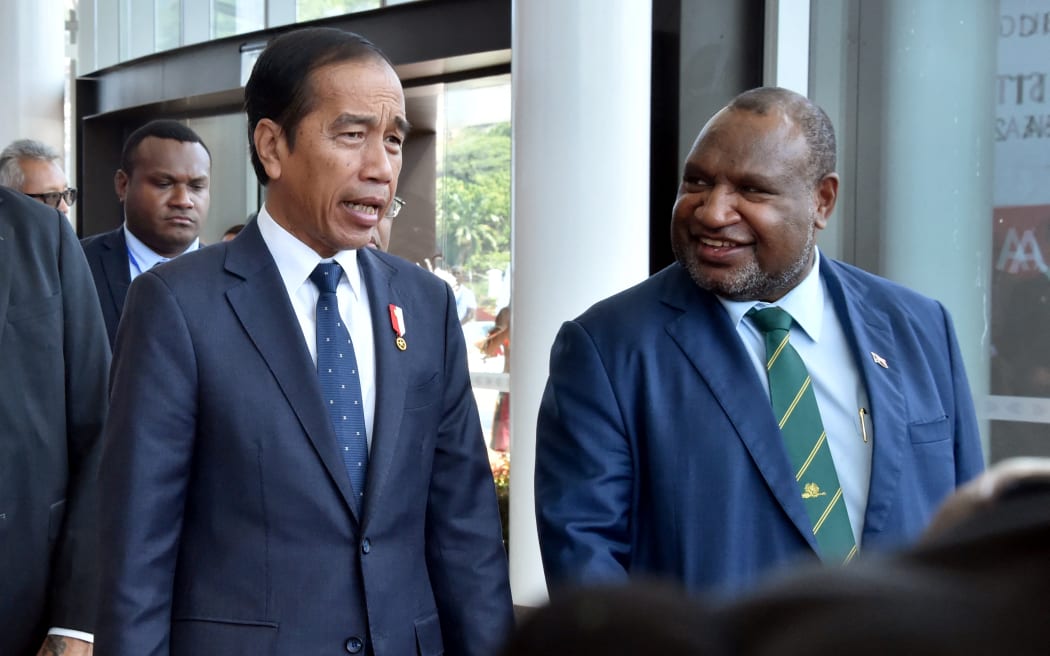 Indonesia's President Joko Widodo (L) is greeted by Papua New Guinea Prime Minister James Marape at APEC Haus ahead of bilateral meetings in Port Moresby.