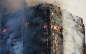 Smoke billows from Grenfell Tower as firefighters attempt to control a huge blaze on June 14, 2017 in west London. The massive fire ripped through the 27-storey apartment block in west London in the early hours of Wednesday