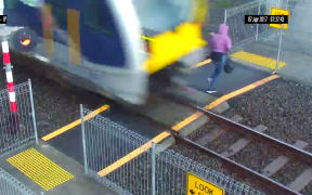 A train driver was forced to slam on his emergency brakes after a woman stepped out despite warning bells and lights, Auckland Transport says.