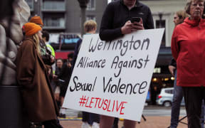 People gathered on Courtenay Place in Wellington to rally against sexual violence.