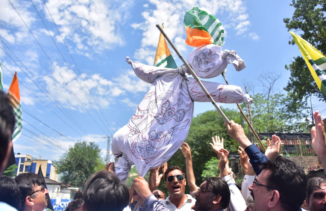 Pakistani Kashmiri hold an effigy of Indian Prime Minister Narendra Modi during a protest in Muzaffarabad, the capital of Pakistan-controlled Kashmir.