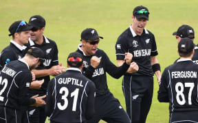 Ross Taylor and Black Caps players celebrate the wicket of India's Virat Kohli after a review during their 2019 Cricket World Cup semi-final.