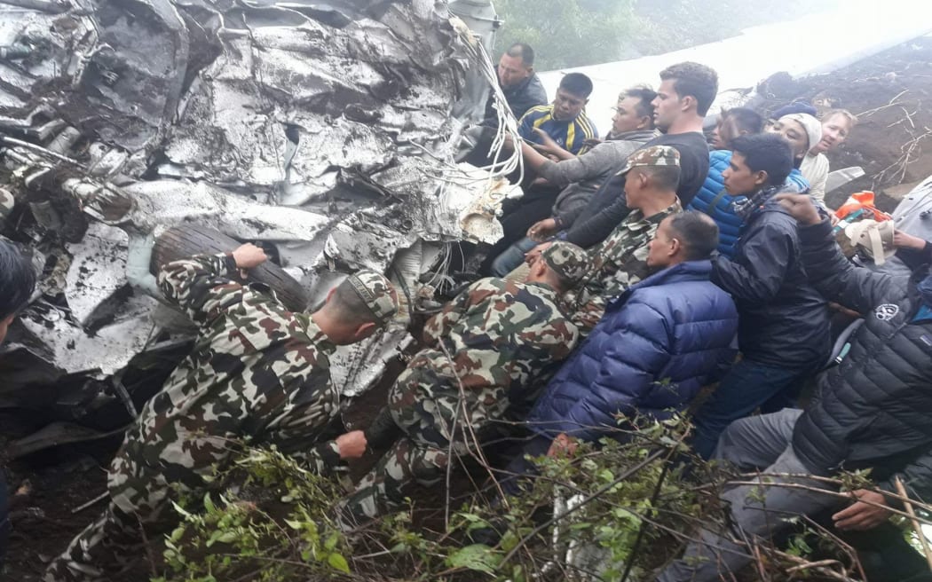 Andrew Roy with rescuers at the cockpit of the crashed plane.