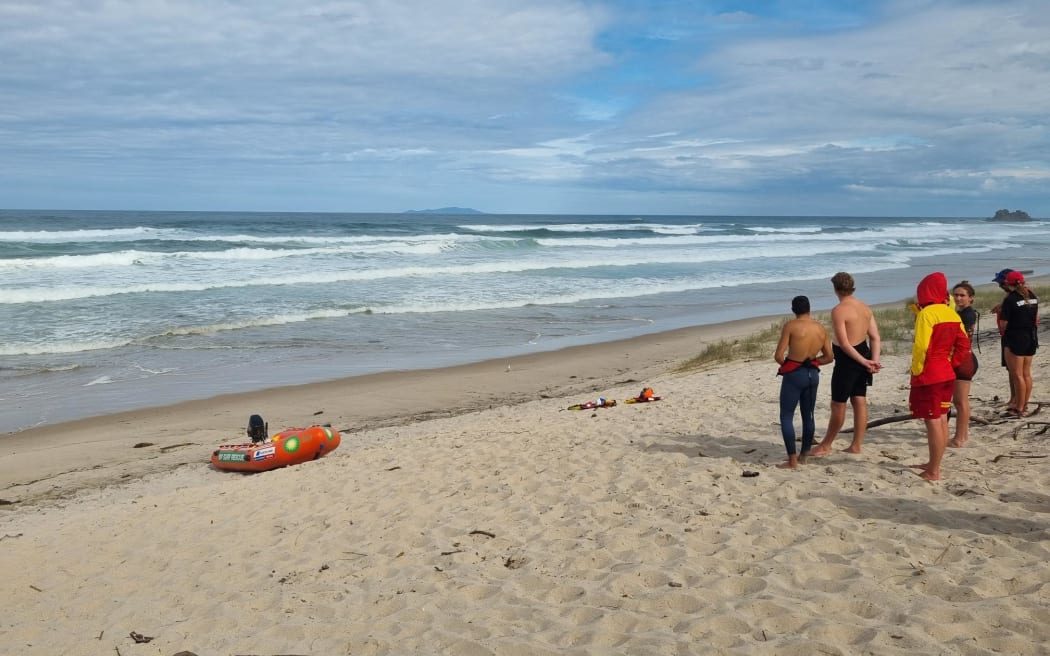 Surf Rescue crews at Opoutere Beach after a group of seven people signaled for help.