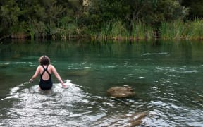 A swimmer in a New Zealand river