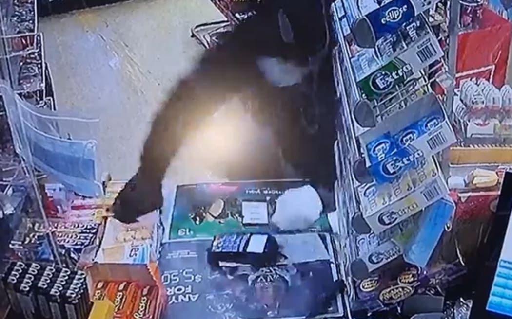 The moment a robber jumped onto the counter at New Plymouth's Windmill Dairy.