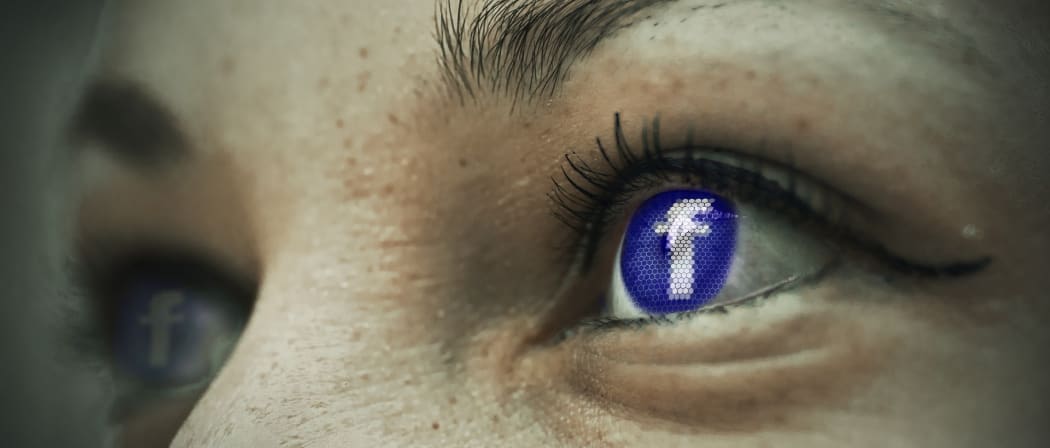 Facebook logo reflected in a woman's eye