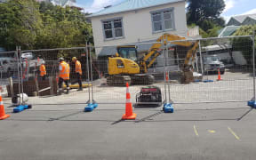 Workers at the site of the main break in Helen Street in the Wellington suburb of Brooklyn.