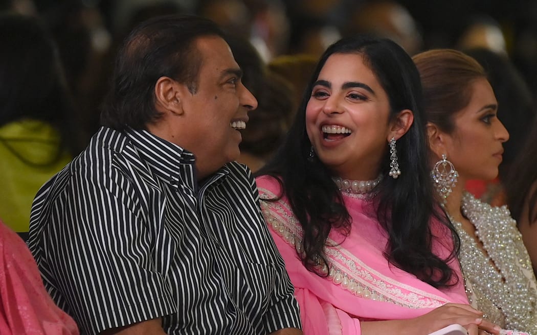 Indian businessman Mukesh Dhirubhai Ambani (Chairman and managing director of Reliance Industries) (C) and his daughter Isha Ambani (R) attend the Manish Malhotra fashion show during ‘The Bridal couture show’ in Mumbai on July 20, 2023. (Photo by SUJIT JAISWAL / AFP)