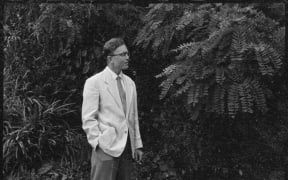 Portrait of Douglas Lilburn taken in the garden of his house at 22 Ascot Terrace, Thorndon, Wellington, 1960s.